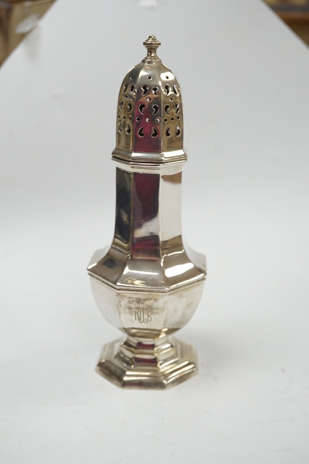 A George V silver octagonal sugar caster, Birmingham, 1918, 18.3cm, 5.5oz. Condition - poor to fair